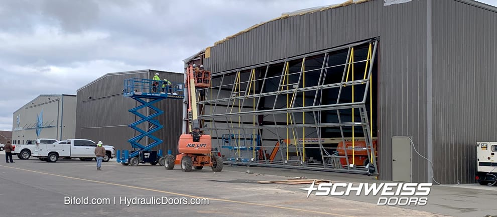 Schweiss bifold door frame being fitted onto SEI hangar at Morristown Regional Airport