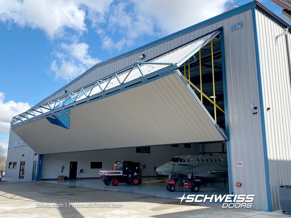 Exterior view of 80 ft Schweiss bifold door fitted on SEI's Hangar A at Morristown Regional Airport shown opening