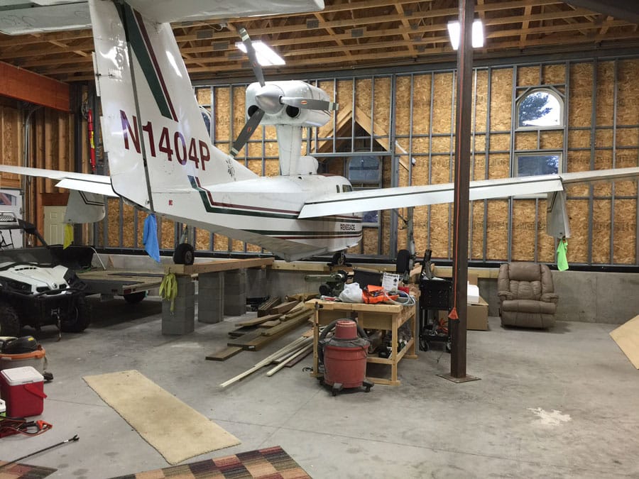 The nose of this amphibious hulled aircraft sits perfectly inside its custom-made door bumpout.