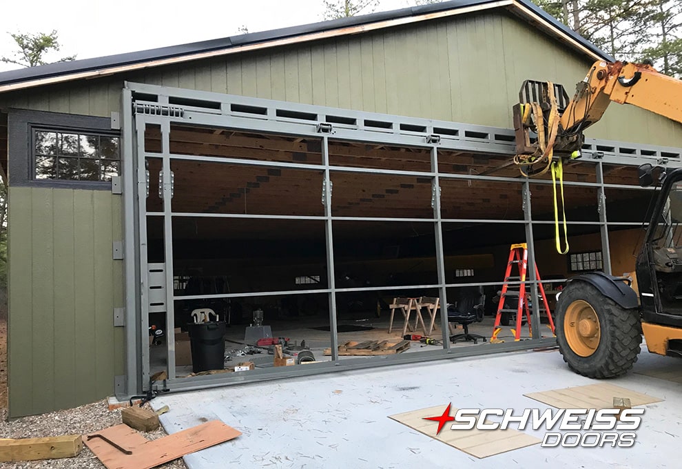 Schweiss hydraulic door being installed on Andrew's personal hangar