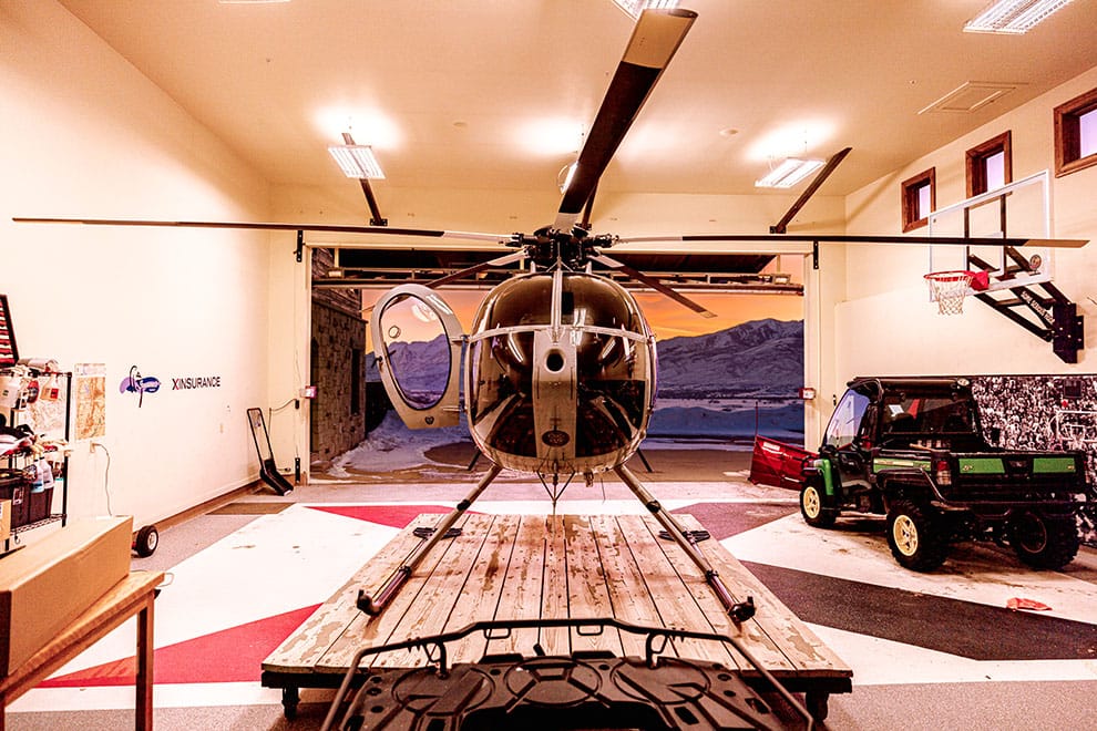 Front view of helicopter stored in Rick Lindey's hangar garage fitted with Schweiss Lift Strap Bifold door