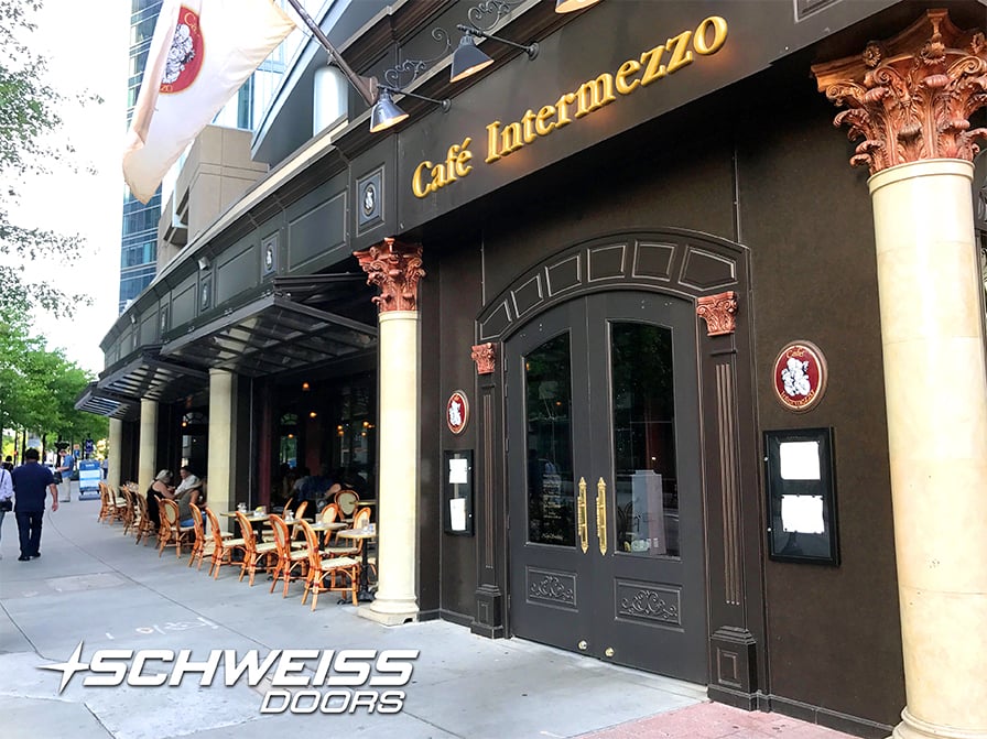 Schweiss bifold doors provides awning for guests at Cafe Intermezzo