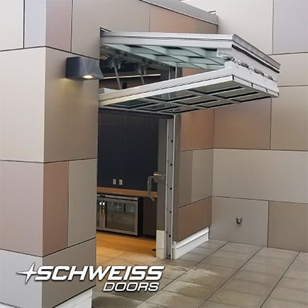 Schweiss designer doors clad in glass