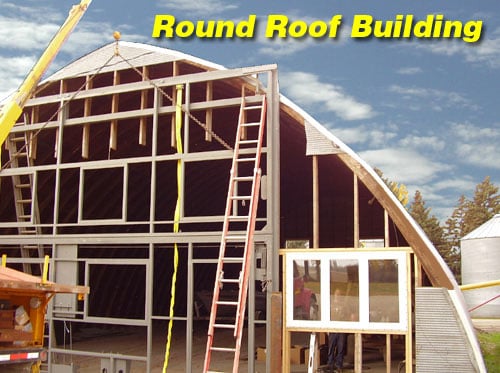 Schweiss Bifold Door Skeleton Being Installed on a Round Roof Building