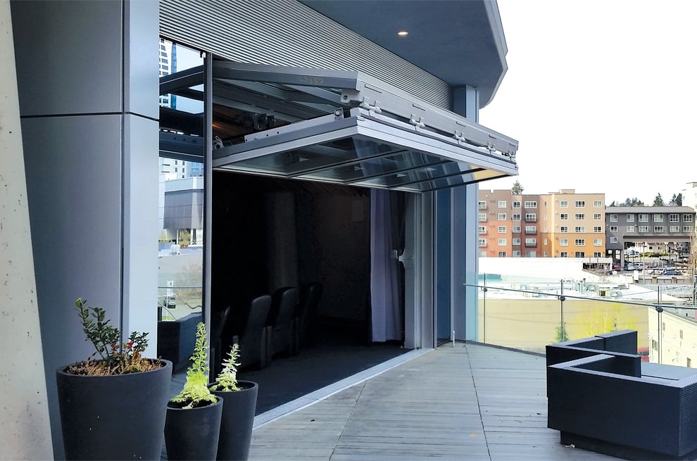 Schweiss bifold designer glass doors open Washington Apartments piazza