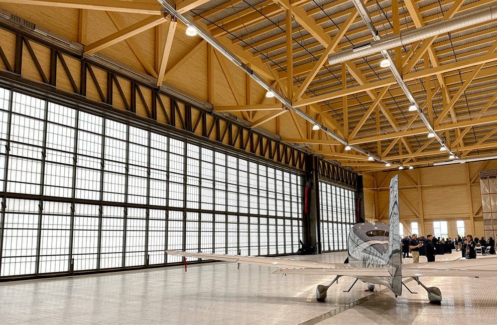 Small aircraft parked inside hangar fitted with 120ft Schweiss Stand-Alone Hydraulic Door