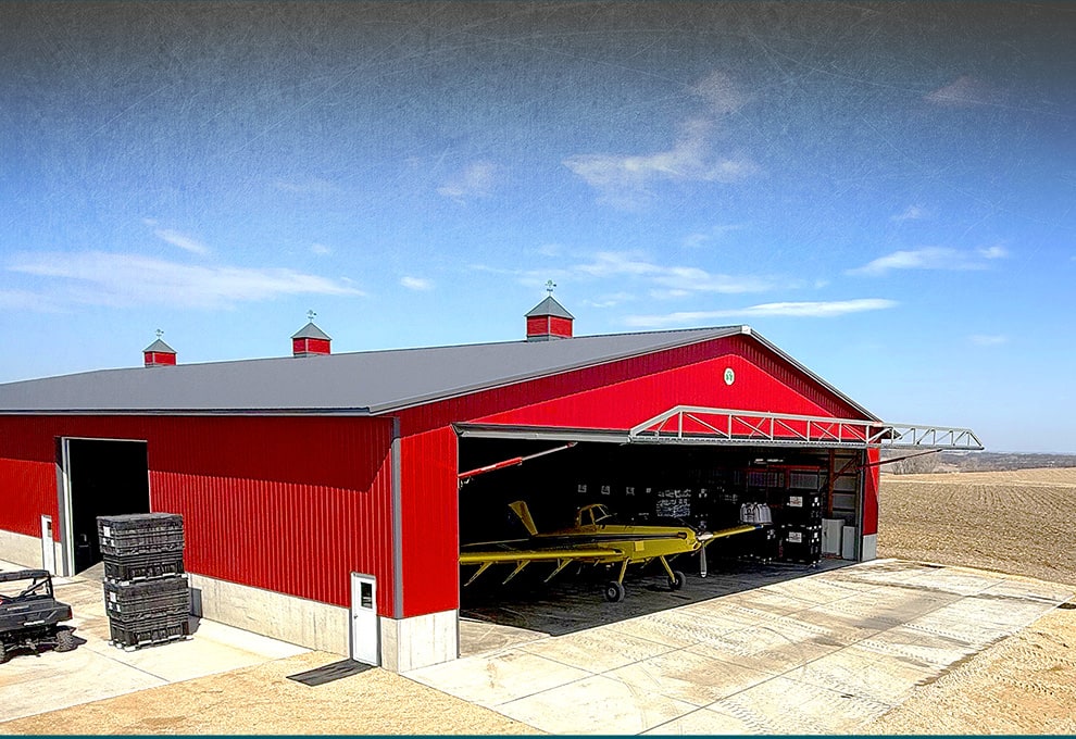 Georgia hydraulic door by Schweiss used on red hangar with yellow plane inside