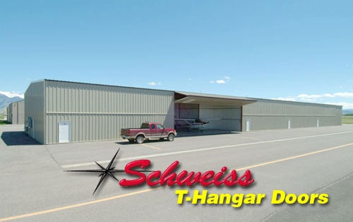 Nested Hangar with an Open Bifold Door at an Airport