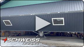 Schweiss bifold door fitted on Alaskan hangar home, owners explain their choice