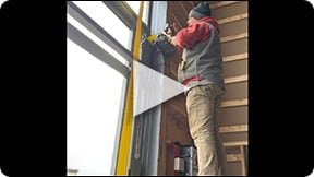 Schweiss crew installs Schweiss Strap Latches on Schweiss Bifold Door