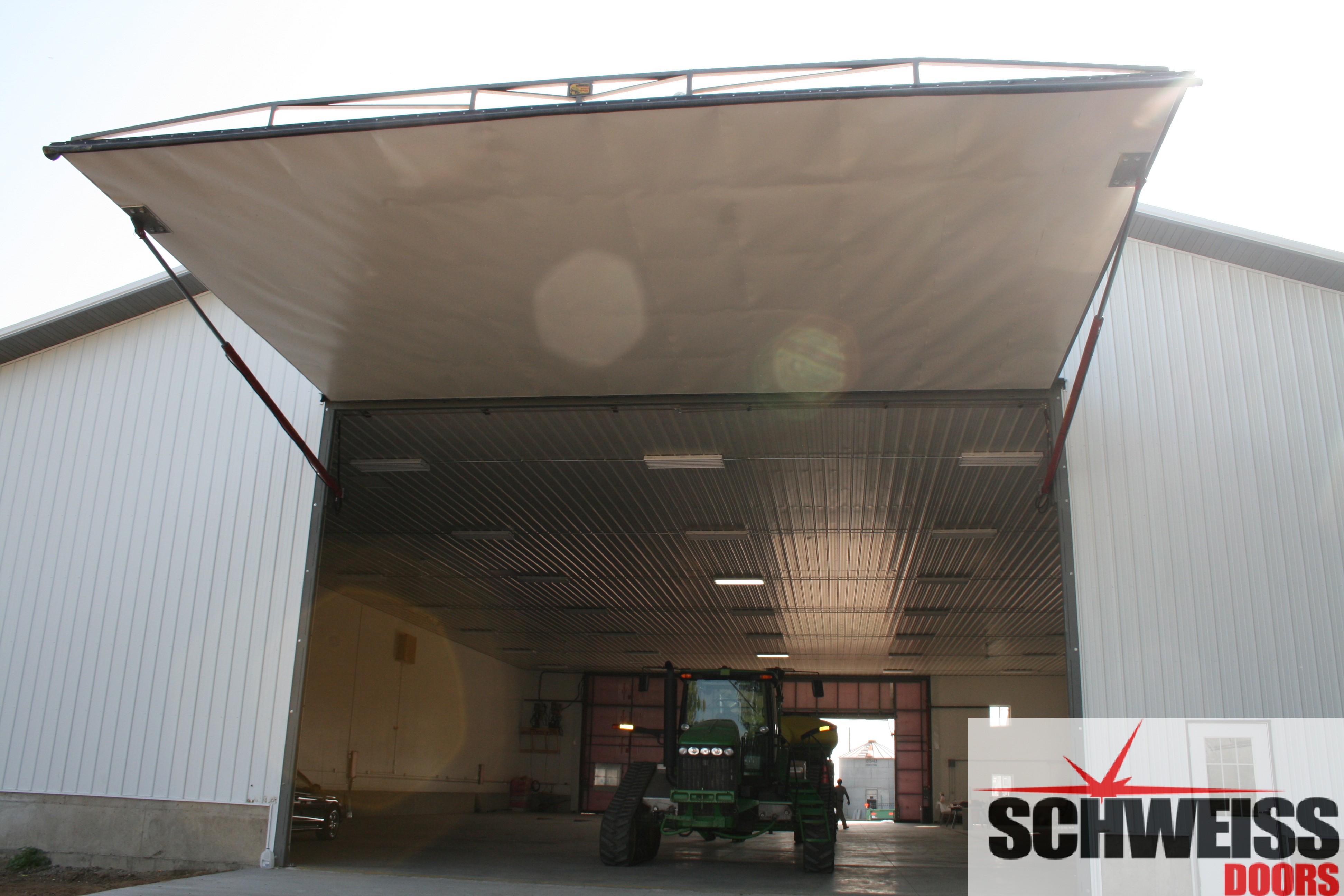 Farm machine shed bifold liftstrap door