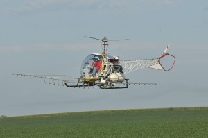 Flying evenly and steady over a field to deliver precise spraying patterns is an advantage of a helicopter.