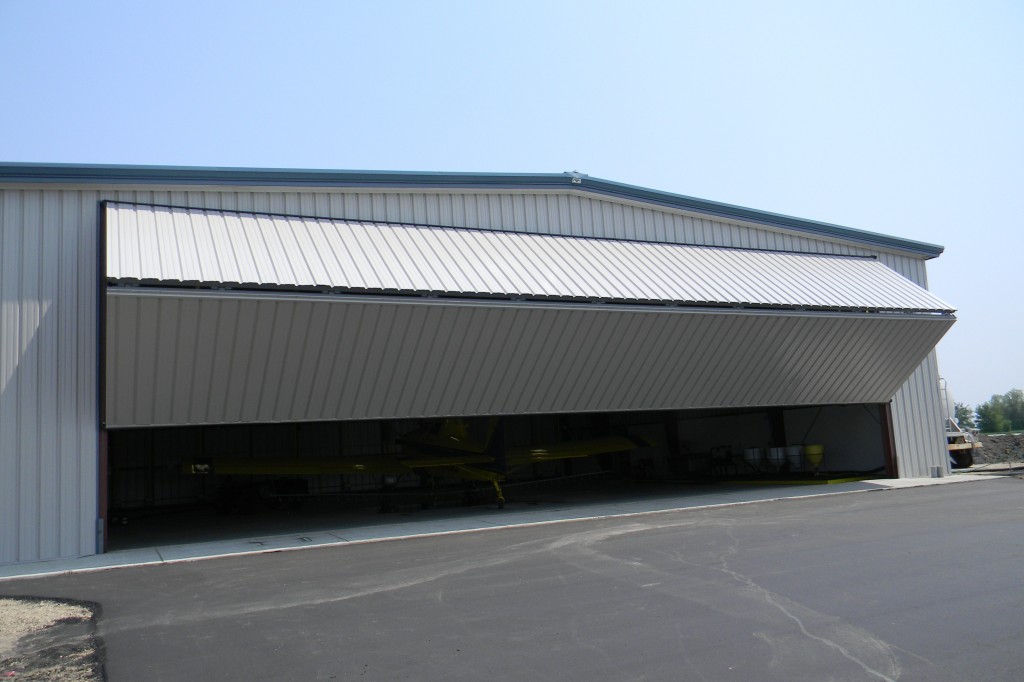 Time is money for aerial crop sprayers. Two large 65 ft. bifold doors on this hangar can be opened by remote control by the pilot.