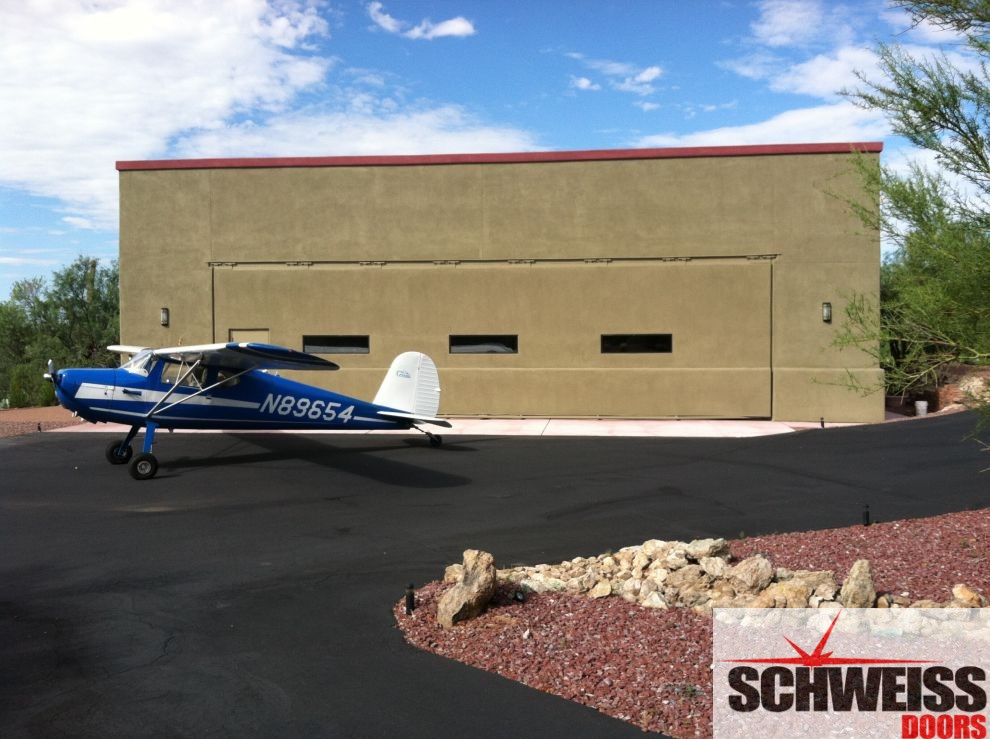 Arizona stucco clad aircraft hydraulic hangar door