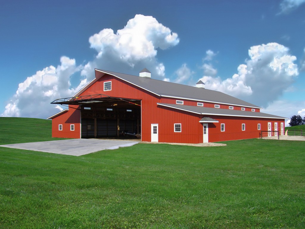 This "Country Style" red barn has a 40 ft. Schweiss hydraulic one piece door on it. It's owned by an Illinois crop sprayer and gives him easy access to bring his choppers into the work shop.