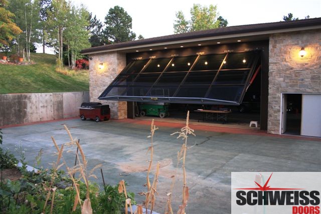 Hydraulic patio and garage doors with glass exterior