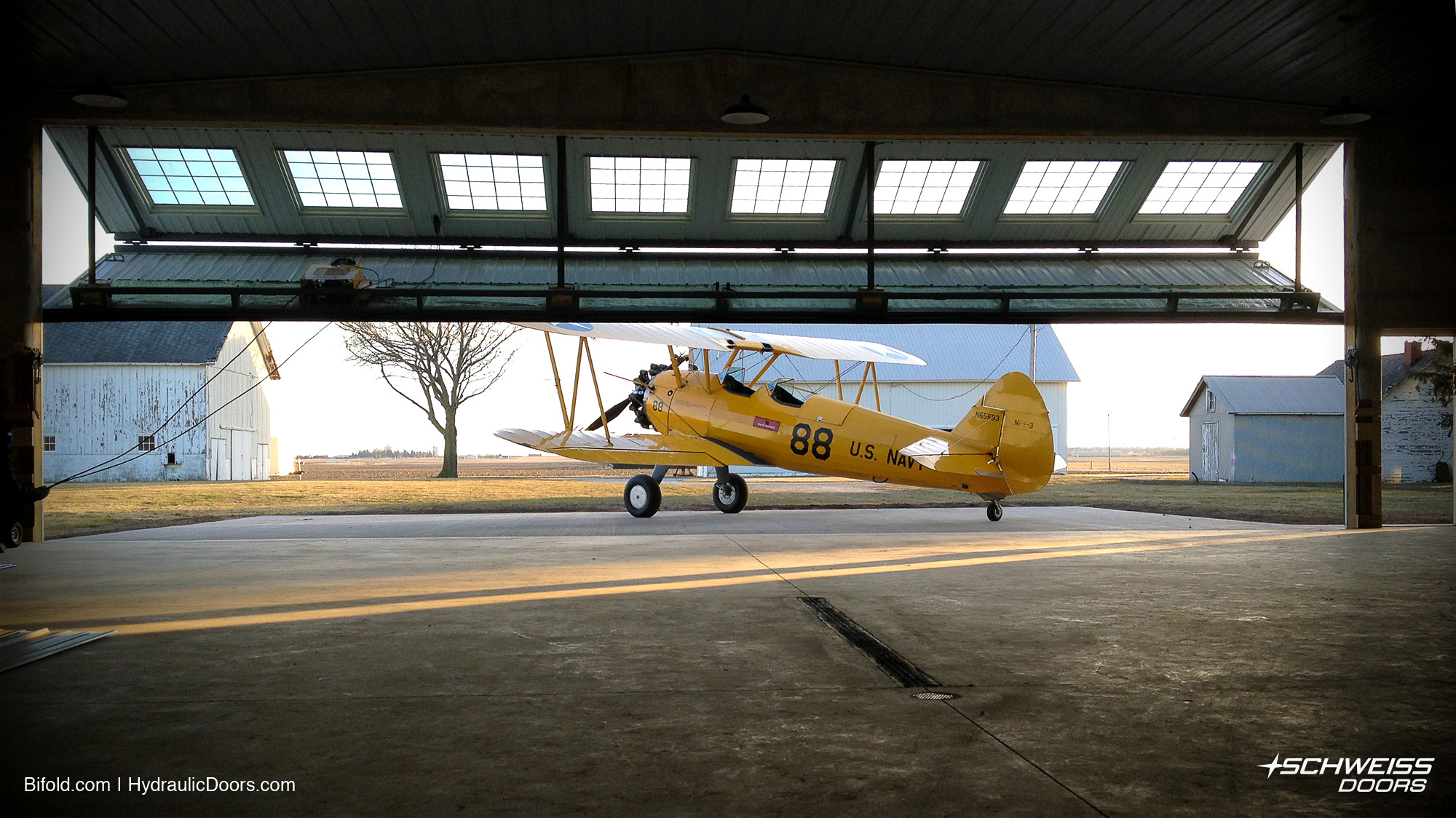 Schweiss Hangar Door opens to let Bi-Plane out of hangar